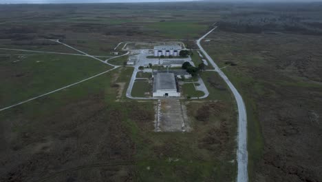 Aerial-establishing-reveal-of-abandoned-military-base-and-Voice-of-America-radio-station-headquarters-in-Greece