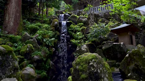 Beautiful-waterfall-and-small-river-at-Buddhist-Temple-in-lush-forest