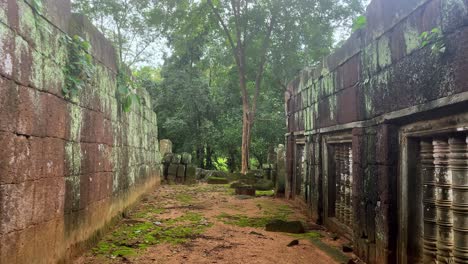 POV-dolly-in-of-mossy-ruins-at-the-Beng-Mealea-temple-in-Cambodia,-a-historical-and-touristic-site-currently-demined