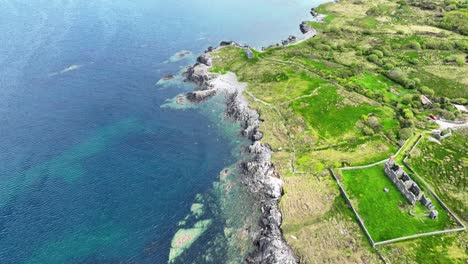 Ireland-epic-locations-Drone-abandoned-military-base-in-Adrigole-West-Cork-with-rugged-coastline-blue-seas-and-emerald-green-farmland-in-summer