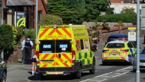 Police-and-paramedic-ambulance-attending-emergency-road-traffic-incident-in-British-neighbourhood