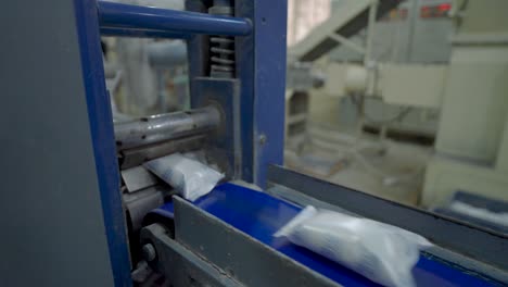 Soap-Bars-Being-Sealed-In-Packaging-Along-Conveyor-Belt-In-Factory