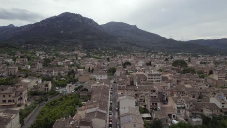 Aerial-forward-ancient-village-Soller-in-Mallorca-on-a-cloudy-day