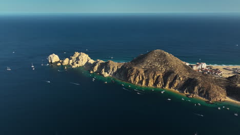 Panoramic-drone-shot-circling-the-cape-of-Cabo-San-Lucas,-sunny-day-in-Mexico
