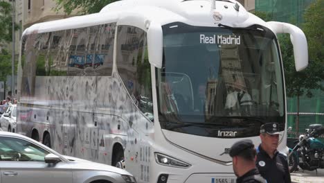 The-Real-Madrid-team-and-bus,-escorted-by-police,-arrive-at-the-reception-as-part-of-the-celebration-of-winning-the-36th-Spanish-soccer-league-title-in-Madrid,-Spain
