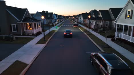 Tesla-EV-driving-in-modern-American-neighborhood-during-dusk-sunset