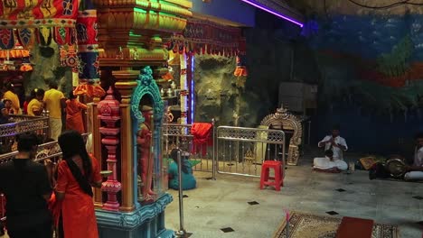 Indian-People-inside-Hindu-Temple-during-Offering-Rituals,-Batu-Cave-in-Kuala-Lumpur