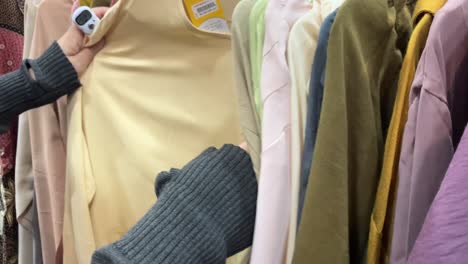 footage-of-woman-selecting-her-choice-clothes-in-a-department-store