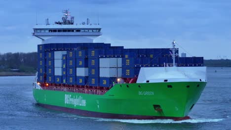 Freight-Ship-Of-BG-Green-Shipping-Containers-Across-The-River-In-Barendrecht-Near-Rotterdam,-South-Holland,-Netherlands