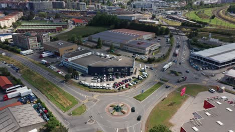 Aerial-of-a-car-dealership-with-several-cars-on-parking-lot-on-an-industrial-terrain