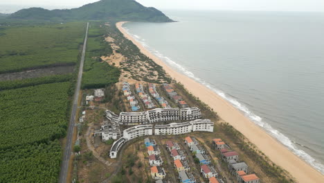 Drone-Rise-Track-Back-Over-Abandoned-Resort-In-Lang-Co-Vietnam