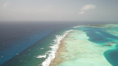 The-vibrant-barrier-reef-along-sebastopol-in-los-roques,-showcasing-turquoise-waters,-aerial-view