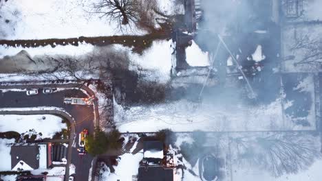 Winter-school-fire-in-Montreal-from-above,-smoke-billowing,-emergency-services-on-site,-snowy-day