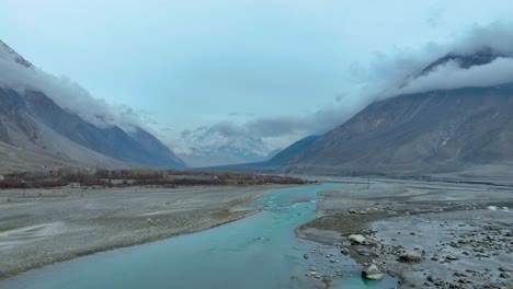 Aerial-View-Of-Hunza-River-Flowing-Through-Nomal-Valley-Landscape-In-Gilgit