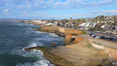 Scenic-Coastal-View-of-Cliffs-and-Residential-Area-in-San-Diego,-CA-during-golden-hour-in-aerial-pedestal-up