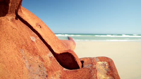 Large-Rusted-Pipe-Sits-Barnacled-on-Beach