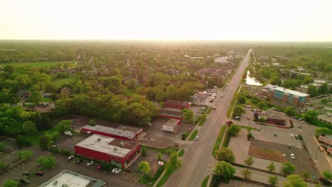 Sunset-orbiting-aerial-view-of-Arlington-Heights,-Illinois,-highlighting-residential-and-commercial-areas-with-lush-greenery