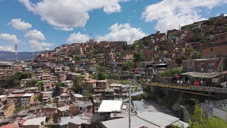 People-visiting-comuna-13-slum-district-in-Medellin-during-sunny-day,-Columbia