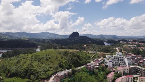 Drone-flyover-Famous-Rock-of-Guatapé-in-scenic-Natural-Landscape,-Colombia