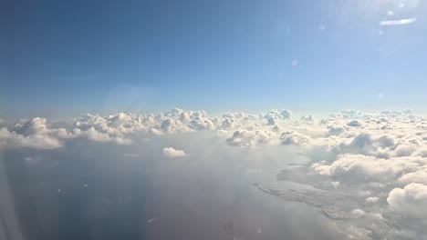 Aerial-view-of-sunrise-through-airplane-window-in-the-morning