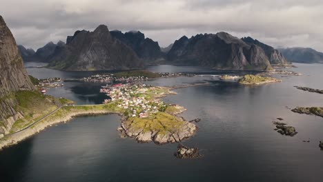 Aerial-view-of-Reine-with-beautiful-sunlight-and-the-mountains-in-the-background,-Lofoten-Islands,-Norway