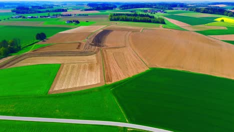 Aerial-View-of-Agricultural-Fields-with-Green-and-Brown-Patches-in-Countryside