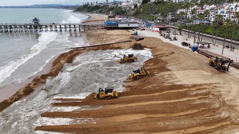 Heavy-machinery-moves-sand-during-a-beach-restoration-project-in-San-Clemente,-California