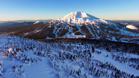 Aerial-shot-captures-mountain-at-sunrise,-bathed-in-stunning-alpenglow