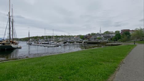 Wide-shot-of-Camden-Maine-waterfront-with-path-and-grass-in-the-foreground