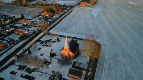Aerial-of-church-at-sunset-in-winter