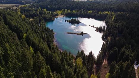 High-orbital-aerial-shot-of-Gold-Creek-Pond-and-Evergreen-Forest-in-Washington-State