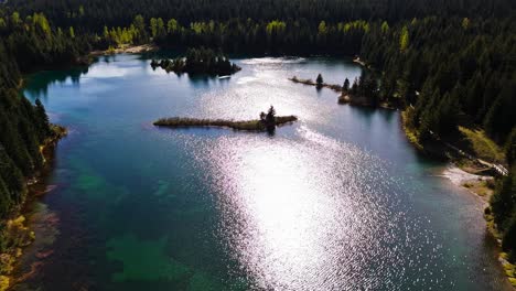 Ascending-aerial-view-of-Gold-Creek-Pond-with-clear-blue-water-in-Washington-State