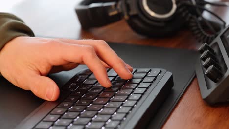 Close-up-of-male-hand-operating-a-keyboard-in-a-professional-video-editing-setup