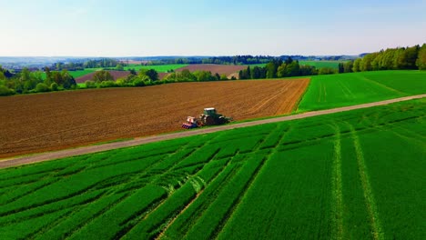 Aerial-View-of-Tractor-Working-on-Green-and-Brown-Farmland-in-Countryside