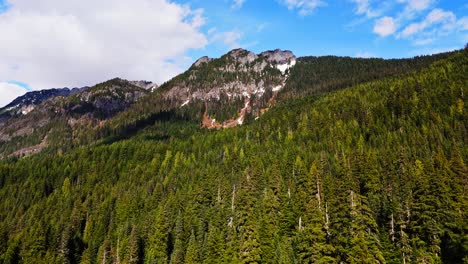 Wunderschöne-Luftaufnahme-über-Immergrünen-Wald-In-Richtung-Eines-Berges-Am-Gold-Creek-Pond-Im-Bundesstaat-Washington