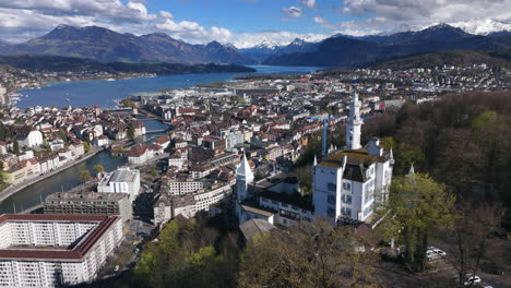 Lucerne-cityscape-with-gütsch-tower-and-lake-in-switzerland,-aerial-view