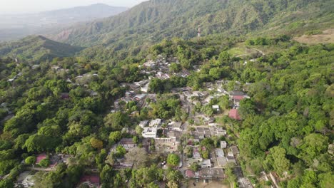Aerial-panoramic-establishing-shot-of-village-of-Minca-Colombia-emerging-from-tropical-jungle-on-hillslope