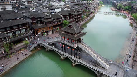 Aerial-circling-Snow-Bridge-over-Tuo-Jiang-River,-Fenghuang-Ancient-City,-China