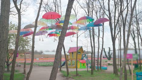 Colorful-hanging-umbrellas-decoration-in-front-of-children's-playground