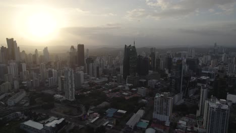 Panama-city-skyline-at-sunrise-with-modern-skyscrapers-and-urban-landscape,-aerial-view