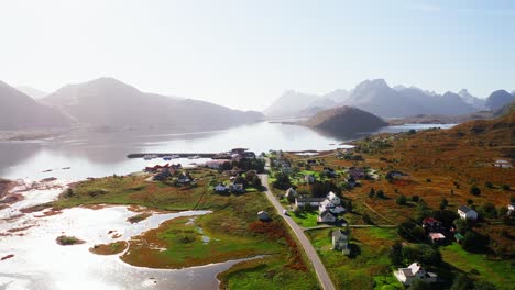 Aerial-view-of-a-white-campervan-arriving-at-Fredvang-on-a-blue-clear-sky-day,-to-do-the-Kvalvika-hike,-Lofoten-Islands,-Norway