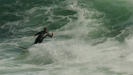 Surfer-gets-a-good-turn-in-slow-motion-in-Santa-Cruz,-CA-at-famous-Steamer-Lane