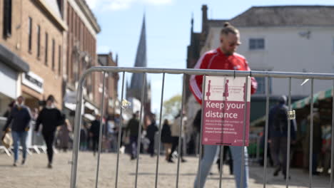 People-walking-down-the-street-in-a-UK-market-town-on-April-12-after-pandemic-lockdown-restrictions-have-been-eased
