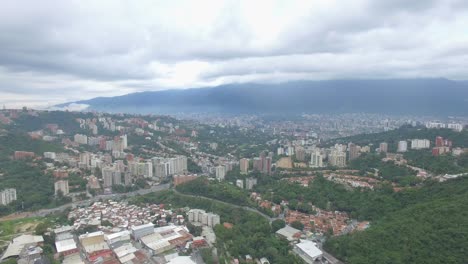 Aerial-view-of-the-merging-between-the-popular-slums-and-the-high-class-neighborhoods-in-Caracas,-Venezuela