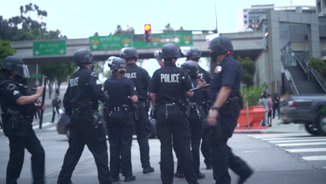 A-group-of-riot-police-group-up-in-the-streets-of-Downtown-at-a-BLM-protest