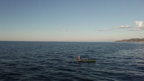 Aerial-fish-canoeing-in-the-middle-of-the-sea-drone-shot