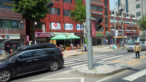 Shot-of-street-from-moving-bus-in-Seoul,-South-Korea