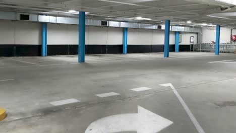 Moving-through-an-undercover-car-park-with-a-leaking-ceiling-and-very-few-vehicles-occupying-the-spaces