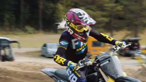 Female-motocross-rider-drives-through-a-banked-corner-in-slow-motion