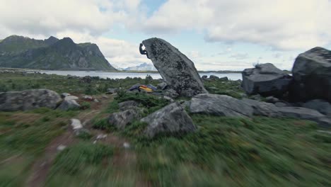 Strong-person-practices-free-climb-on-coastal-rock-in-Norway,-Lofoten